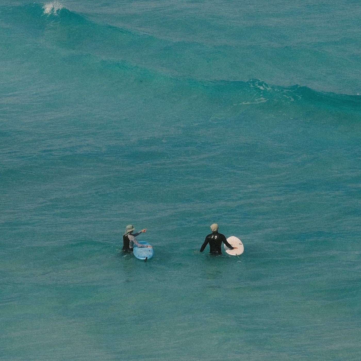 Surfing coach showing a student where and how to surf the waves in Margaret River
